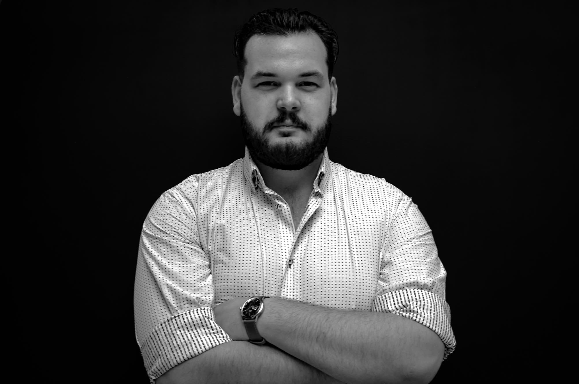 Headshot of Will Brent with his arms crossed